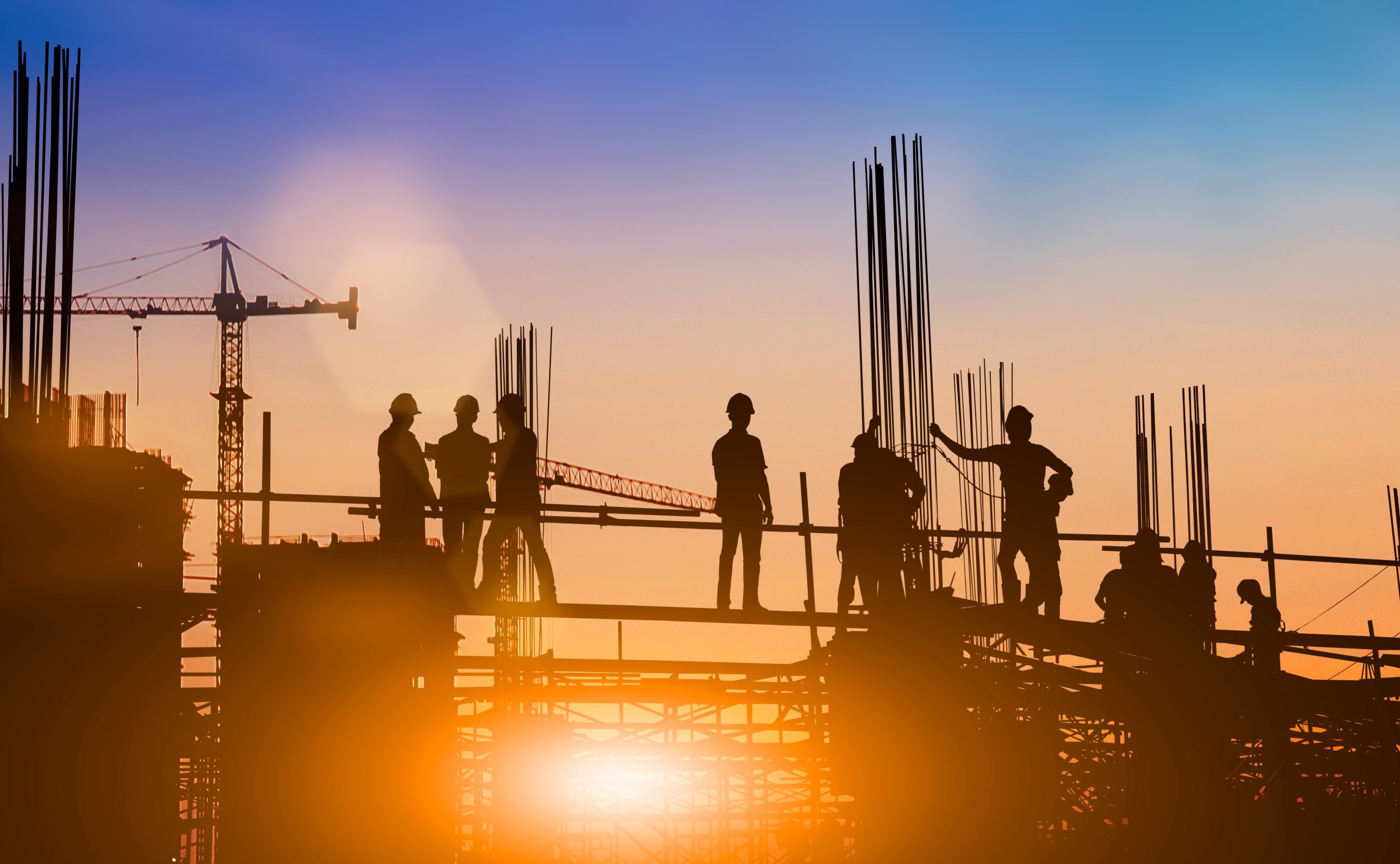 Silhouette of engineer and construction team working at site over blurred background for industry background with Light fair.Create from multiple reference images together